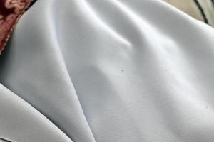 Detailed close up view on samples of cloth and fabrics in different colors found at a fabrics market photo