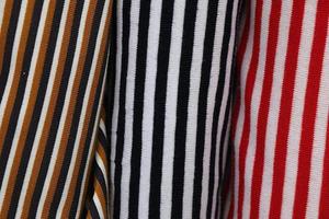 Detailed close up view on samples of cloth and fabrics in different colors found at a fabrics market photo