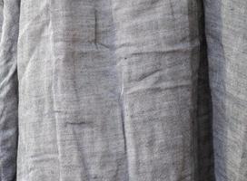 Detailed close up view on samples of cloth and fabrics in different colors found at a fabrics market photo