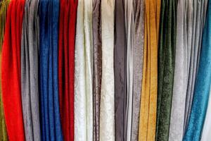 Detailed close up view on samples of cloth and fabrics in different colors found at a fabrics market photo