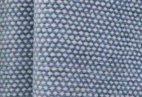 Detailed close up view on samples of cloth and fabrics in different colors found at a fabrics market photo