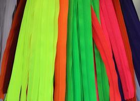 Detailed close up view on samples of cloth and fabrics in different colors found at a fabrics market photo
