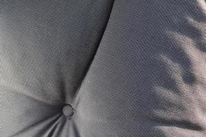 Detailed close up view on samples of cloth and fabrics in different colors found at a fabrics market photo