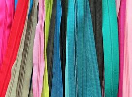 Detailed close up view on samples of cloth and fabrics in different colors found at a fabrics market photo