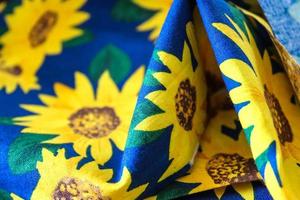 Detailed close up view on samples of cloth and fabrics in different colors found at a fabrics market photo