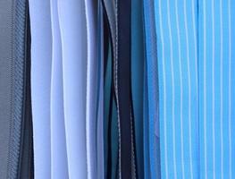 Detailed close up view on samples of cloth and fabrics in different colors found at a fabrics market photo