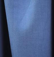 Detailed close up view on samples of cloth and fabrics in different colors found at a fabrics market photo
