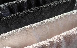 Detailed close up view on samples of cloth and fabrics in different colors found at a fabrics market photo