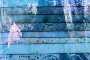 Detailed close up view on samples of cloth and fabrics in different colors found at a fabrics market photo