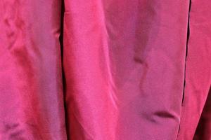 Detailed close up view on samples of cloth and fabrics in different colors found at a fabrics market photo