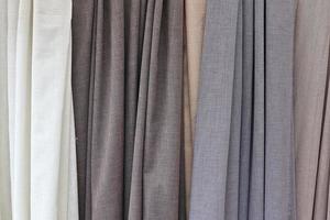 Detailed close up view on samples of cloth and fabrics in different colors found at a fabrics market photo