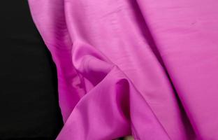 Detailed close up view on samples of cloth and fabrics in different colors found at a fabrics market photo
