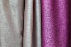 Detailed close up view on samples of cloth and fabrics in different colors found at a fabrics market photo