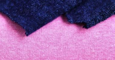 Detailed close up view on samples of cloth and fabrics in different colors found at a fabrics market photo