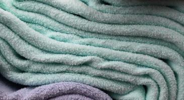 Detailed close up view on samples of cloth and fabrics in different colors found at a fabrics market photo
