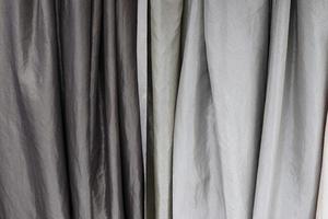 Detailed close up view on samples of cloth and fabrics in different colors found at a fabrics market photo