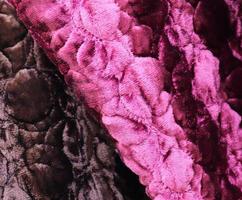 Detailed close up view on samples of cloth and fabrics in different colors found at a fabrics market photo