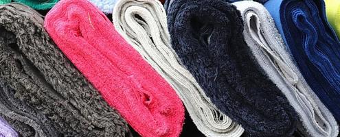 Detailed close up view on samples of cloth and fabrics in different colors found at a fabrics market photo