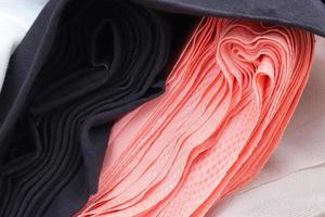 Detailed close up view on samples of cloth and fabrics in different colors found at a fabrics market photo