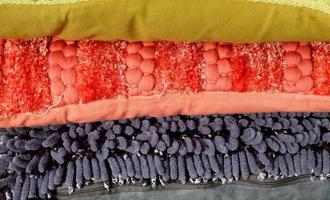 Detailed close up view on samples of cloth and fabrics in different colors found at a fabrics market photo