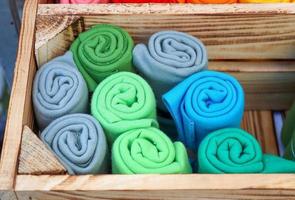 Detailed close up view on samples of cloth and fabrics in different colors found at a fabrics market photo
