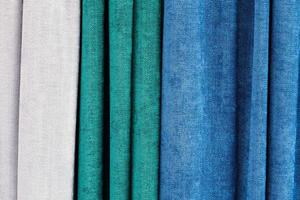 Detailed close up view on samples of cloth and fabrics in different colors found at a fabrics market photo