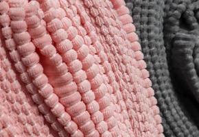 Detailed close up view on samples of cloth and fabrics in different colors found at a fabrics market photo