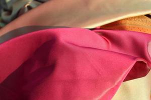 Detailed close up view on samples of cloth and fabrics in different colors found at a fabrics market photo