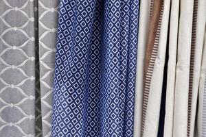 Detailed close up view on samples of cloth and fabrics in different colors found at a fabrics market photo