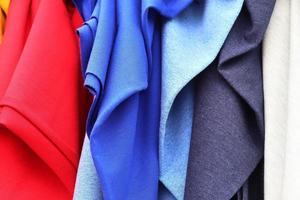 Detailed close up view on samples of cloth and fabrics in different colors found at a fabrics market photo