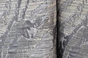 Detailed close up view on samples of cloth and fabrics in different colors found at a fabrics market photo