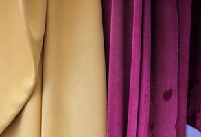 Detailed close up view on samples of cloth and fabrics in different colors found at a fabrics market photo