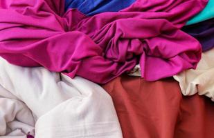 Detailed close up view on samples of cloth and fabrics in different colors found at a fabrics market photo