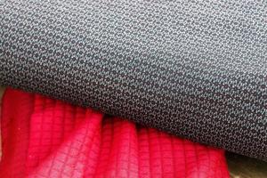 Detailed close up view on samples of cloth and fabrics in different colors found at a fabrics market photo