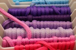 Detailed close up view on samples of cloth and fabrics in different colors found at a fabrics market photo