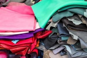 Detailed close up view on samples of cloth and fabrics in different colors found at a fabrics market photo
