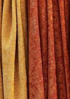 Detailed close up view on samples of cloth and fabrics in different colors found at a fabrics market photo
