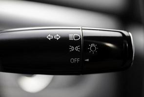 Turn signal lever, adjusting car headlight control switch. photo