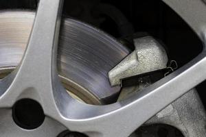 Rusted brake discs and traces of use of a small car, close-up. photo