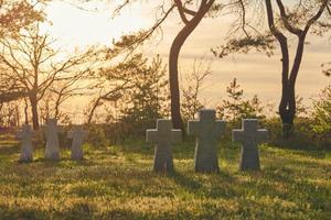 Stone crosses at sunset in German military cemetery, Europe photo