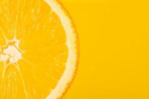 Fresh juicy fruit, orange, yellow background, copy space photo