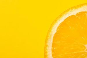 Fresh juicy fruit, orange, yellow background, copy space photo
