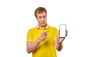 Young man with smartphone mockup in hand, white isolated background, mobile app advertise photo