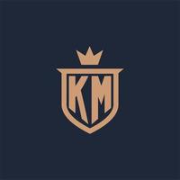 KM monogram initial logo with shield and crown style vector