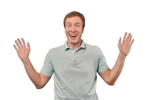 Funny smiling man in T-shirt showing palms of hands, unexpected surprise gesture, white background photo