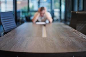 Fired employee in conference room. Manager at table in modern meeting room for business negotiations and business meetings. photo