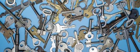 Keys set on blue background. Door lock keys and safes for property security and house protection. Different antique and new types of keys. photo