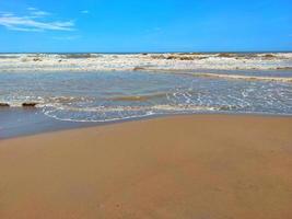 Defocus blurred image of nature landscape view of beautiful tropical beach and sea in sunny day. Beach sea space area. Sea beach with blue sky. photo