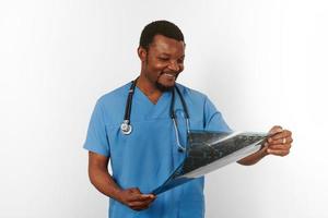 Black surgeon doctor bearded man in blue coat with crossed arms isolated white background copy space photo