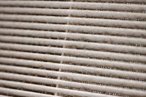 Dirty air ventilation grill of HVAC with clogged filter. photo